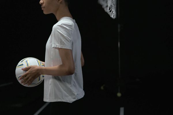 Individual holding a balancing pose, conveying stability and focus.